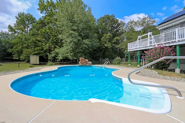 view of swimming pool featuring a deck