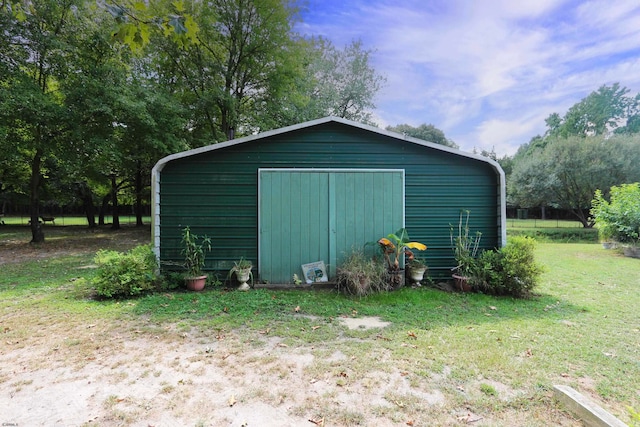 view of outdoor structure featuring a lawn