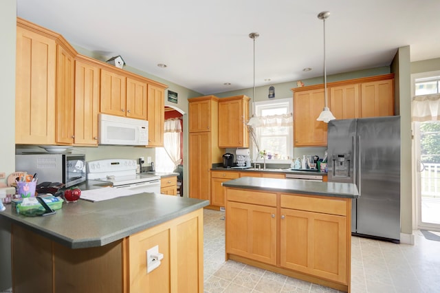 kitchen with decorative light fixtures, stainless steel appliances, and a kitchen island