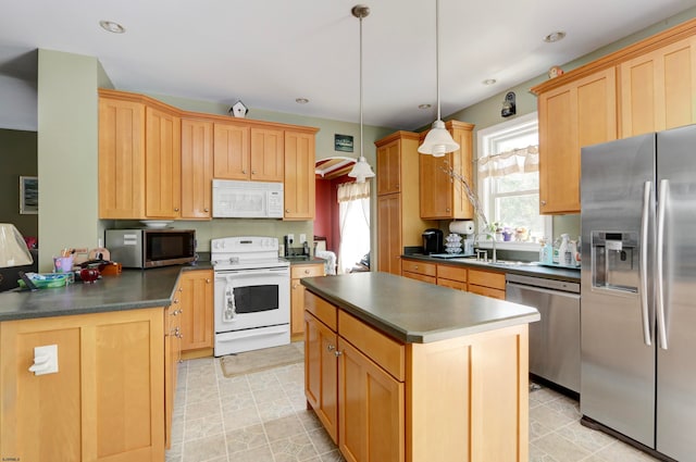 kitchen featuring sink, hanging light fixtures, a kitchen island, light brown cabinets, and appliances with stainless steel finishes