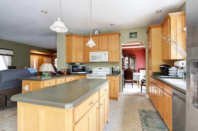 kitchen with a kitchen island, pendant lighting, stainless steel appliances, light brown cabinetry, and a healthy amount of sunlight