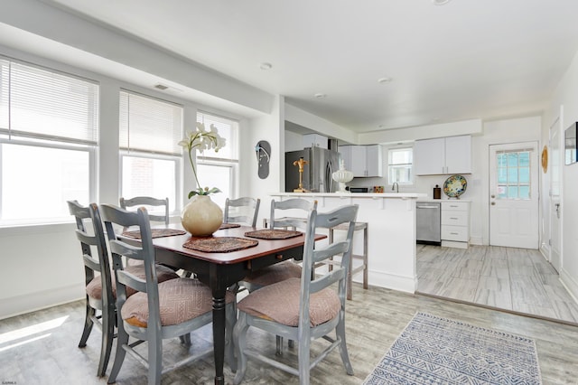 dining room featuring light hardwood / wood-style flooring and a wealth of natural light