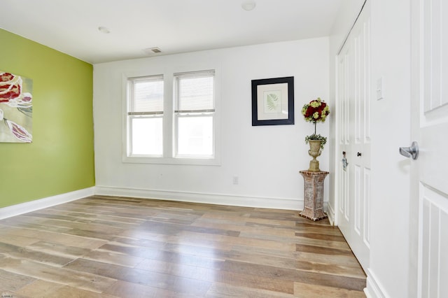 spare room featuring wood-type flooring