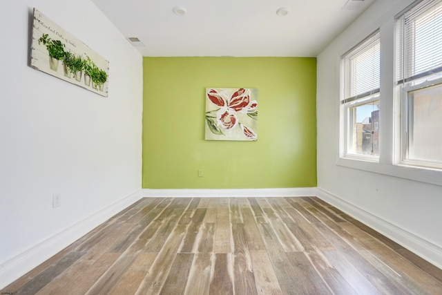 empty room featuring hardwood / wood-style floors and a healthy amount of sunlight