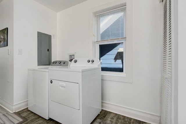 laundry area featuring dark wood-type flooring, electric panel, and washer and dryer