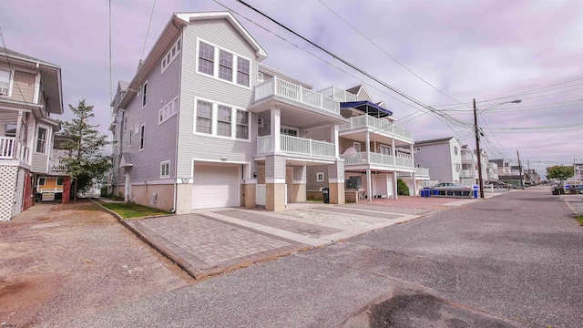 view of front of home with a balcony and a garage