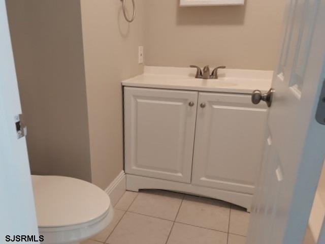 bathroom featuring vanity, toilet, and tile patterned floors