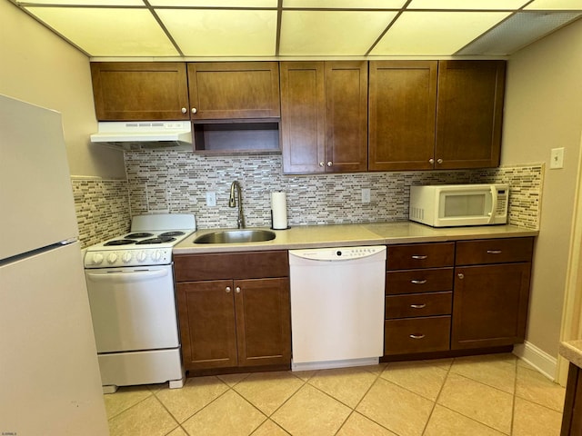 kitchen featuring light tile patterned floors, sink, white appliances, and decorative backsplash