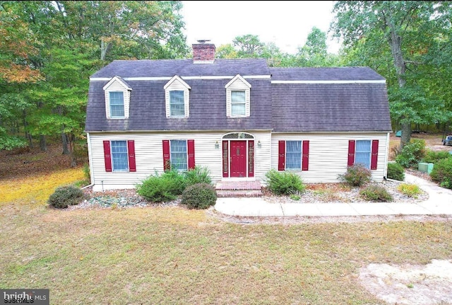 new england style home with a front yard