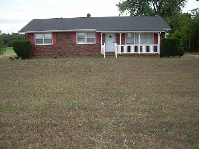 ranch-style house featuring a porch and a front yard