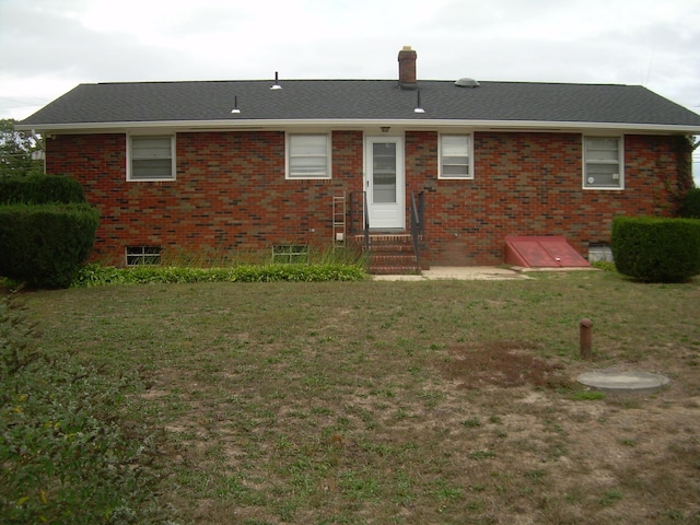 rear view of house with a yard