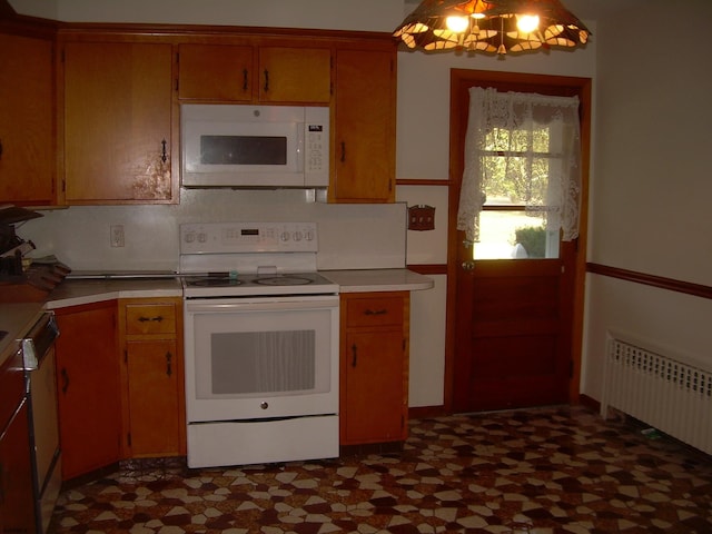 kitchen with radiator heating unit and white appliances