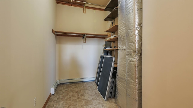 spacious closet with a baseboard heating unit