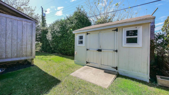 view of outbuilding with a lawn