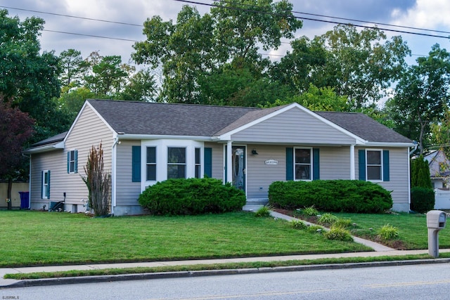 ranch-style home with a front lawn