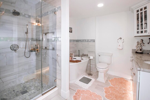 full bathroom with vanity, shower with separate bathtub, toilet, and tile patterned floors