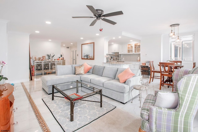 living room featuring ceiling fan and ornamental molding