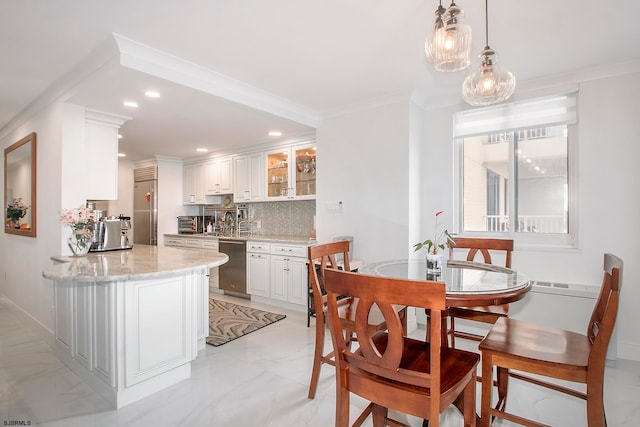 dining room with sink and crown molding