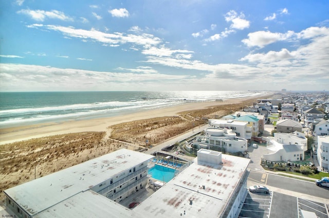 bird's eye view with a water view and a beach view