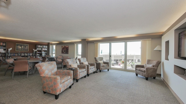 living room with a textured ceiling and light carpet