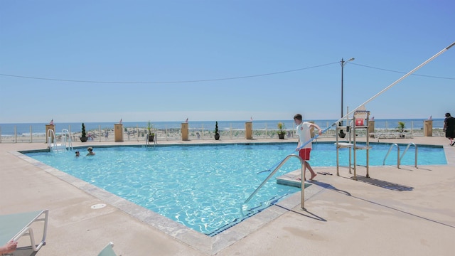 view of pool with a water view