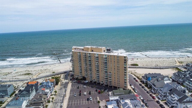 bird's eye view with a water view and a view of the beach