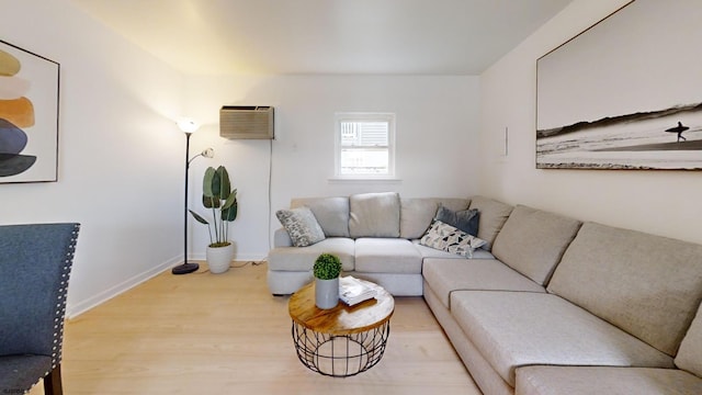 living room with hardwood / wood-style floors and a wall mounted AC