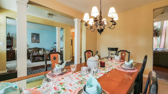 dining room featuring a notable chandelier and ornate columns