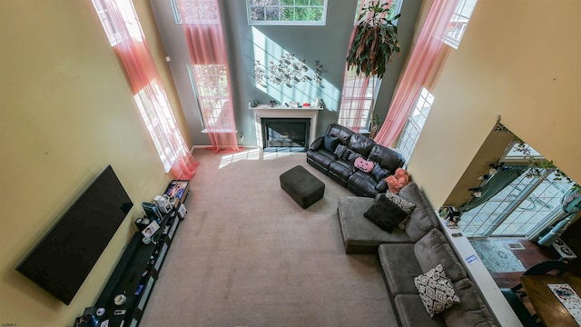 carpeted living room featuring a high ceiling