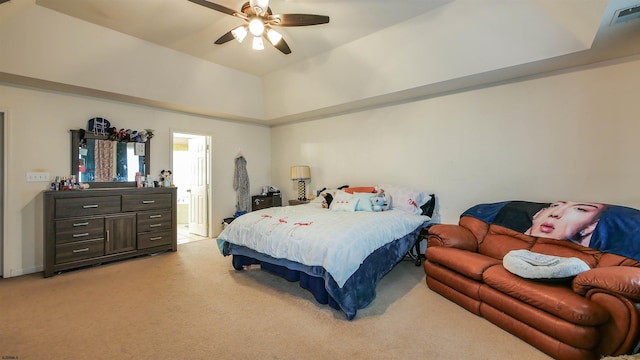 bedroom with ensuite bath, ceiling fan, and light colored carpet