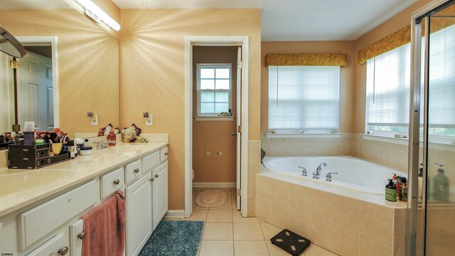 bathroom with shower with separate bathtub, vanity, plenty of natural light, and tile patterned floors