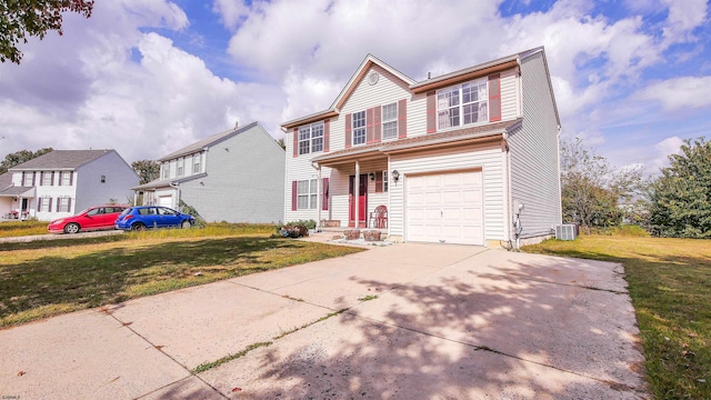 front of property featuring a garage, central AC unit, and a front yard