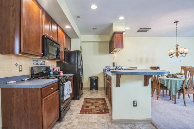 kitchen with backsplash, a chandelier, a kitchen bar, black appliances, and pendant lighting