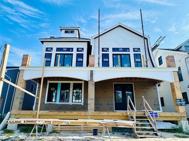 rear view of house featuring a porch