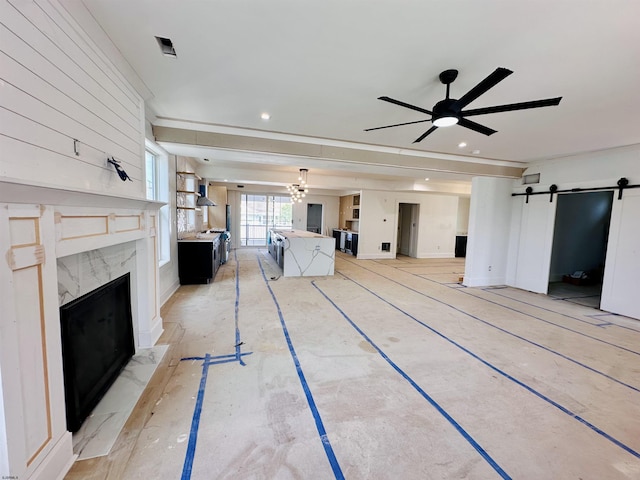 27 Spruce Rd, Ocean City, NJ 08226 - unfurnished living room featuring a barn door, a fireplace, a ceiling fan, and recessed lighting