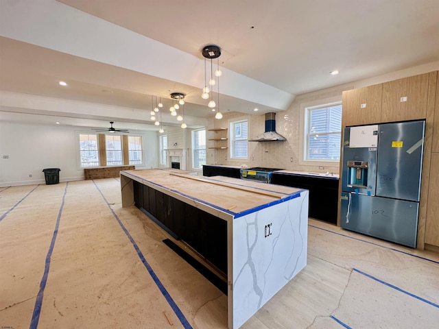 27 Spruce Rd, Ocean City, NJ 08226 - kitchen with stainless steel refrigerator with ice dispenser, wall chimney range hood, decorative light fixtures, modern cabinets, and a center island
