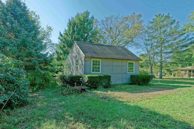 view of outdoor structure featuring a lawn