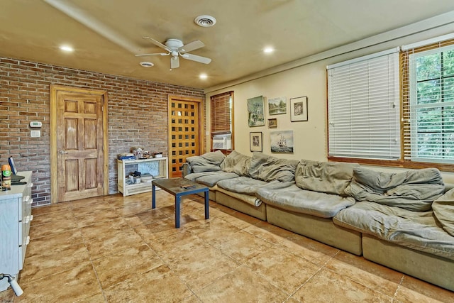 living room featuring brick wall, cooling unit, and ceiling fan