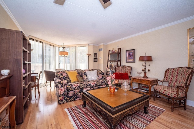 living room with a textured ceiling, ornamental molding, and light hardwood / wood-style flooring