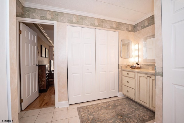 bathroom featuring ornamental molding, tile patterned flooring, a textured ceiling, and vanity