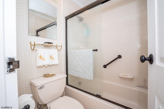 bathroom with ornamental molding, shower / bath combination with glass door, and toilet