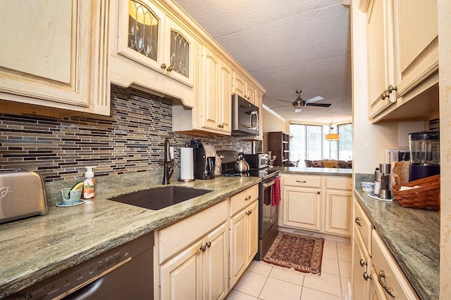 kitchen with ceiling fan, light tile patterned flooring, sink, appliances with stainless steel finishes, and light stone countertops