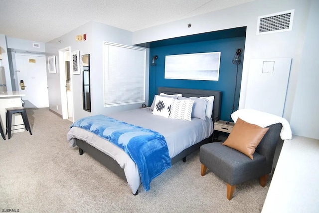 carpeted bedroom with a textured ceiling