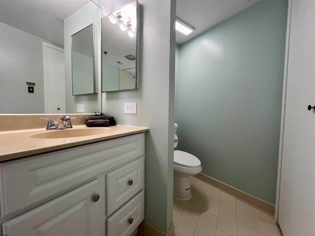 bathroom with vanity, tile patterned flooring, and toilet