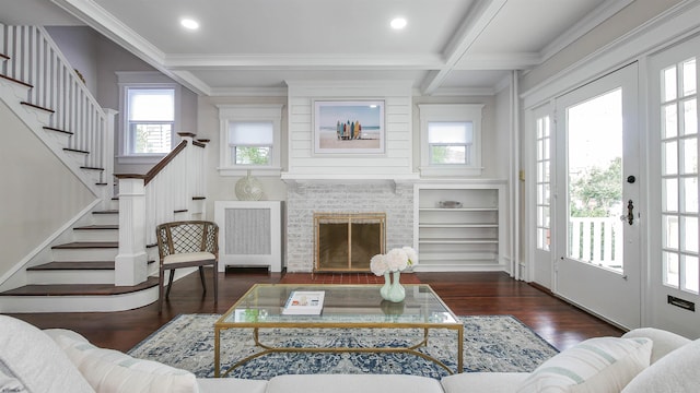 living room with radiator, beamed ceiling, plenty of natural light, and dark wood-type flooring