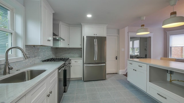 kitchen with pendant lighting, white cabinetry, sink, and stainless steel appliances