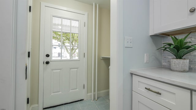 doorway with light tile patterned floors