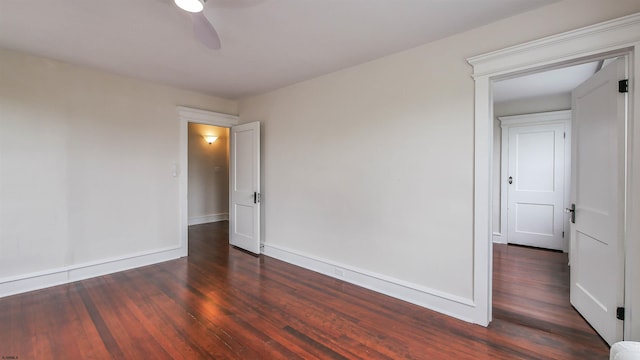 spare room with ceiling fan and dark wood-type flooring