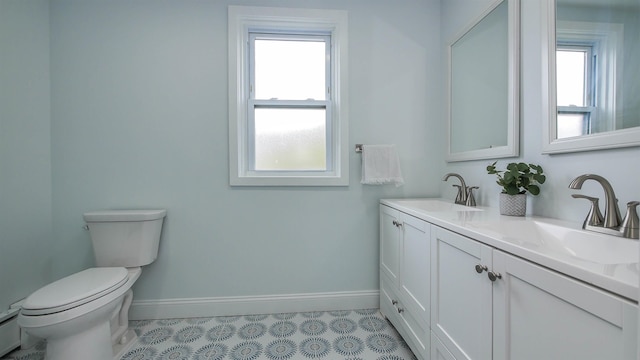 bathroom with vanity, plenty of natural light, toilet, and tile patterned floors