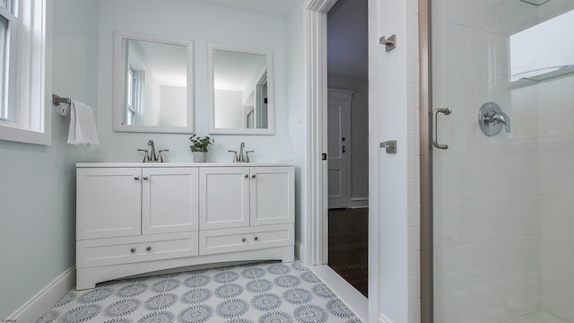 bathroom featuring tile patterned flooring, walk in shower, vanity, and plenty of natural light